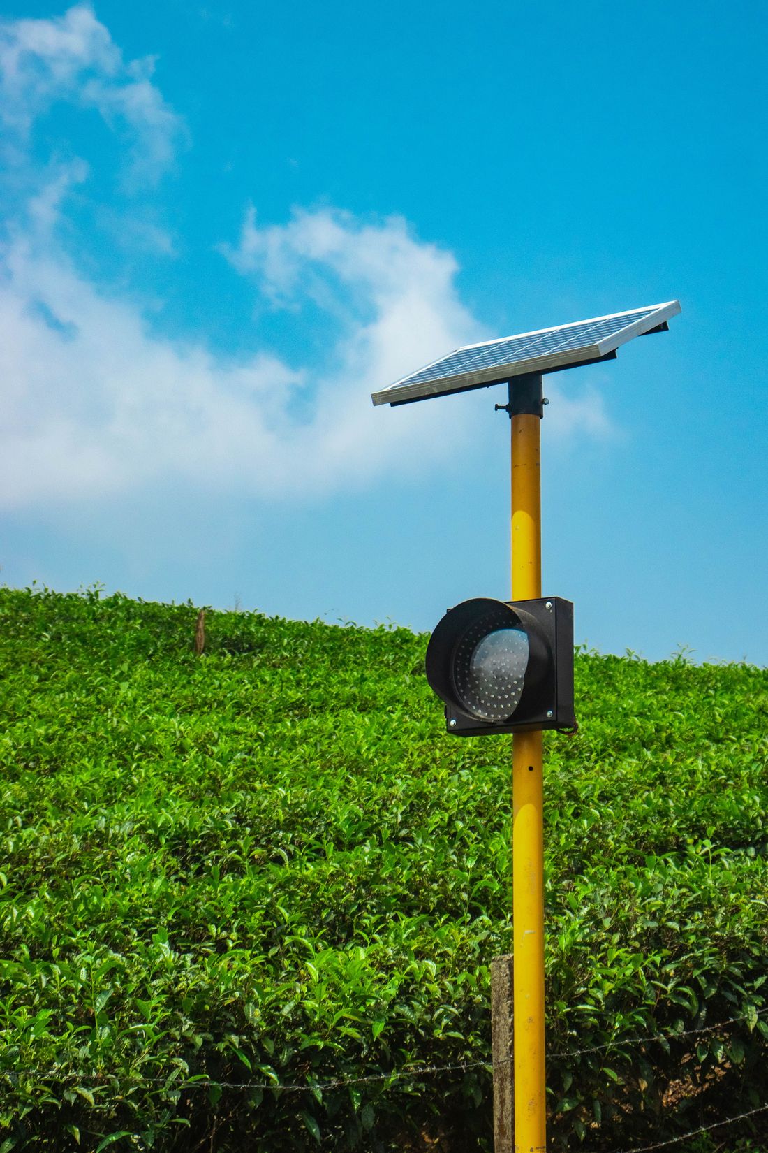 Small solar unit powering equipment beside farmland