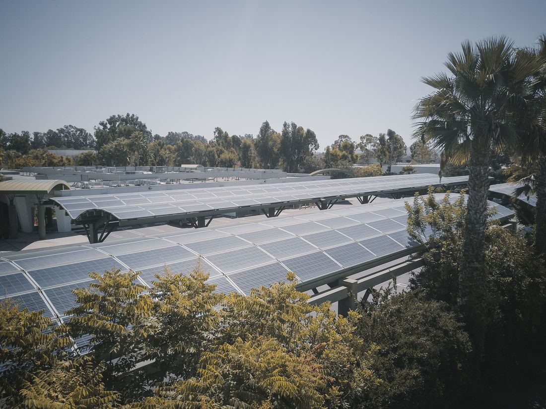 Solar carport structure over a commercial parking area