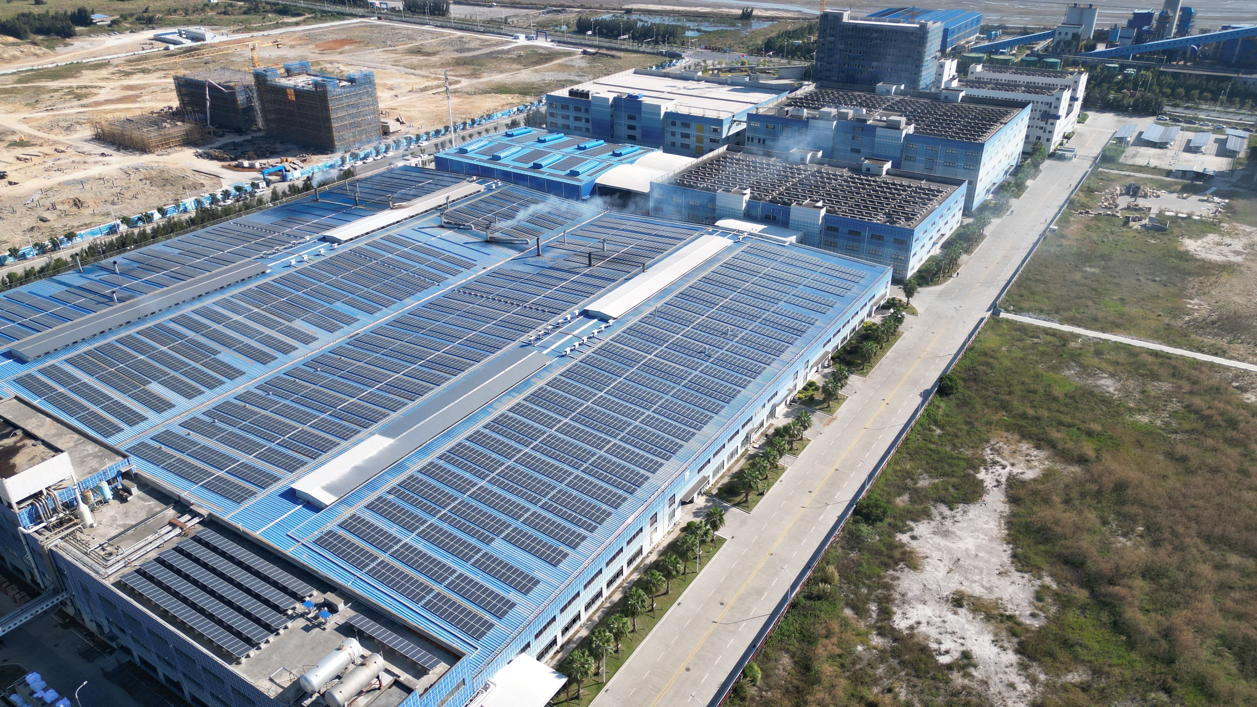 Aerial view of a solar farm in green fields
